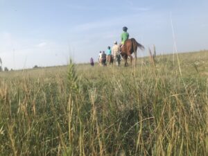 An adaptive riding class participates in a trail ride